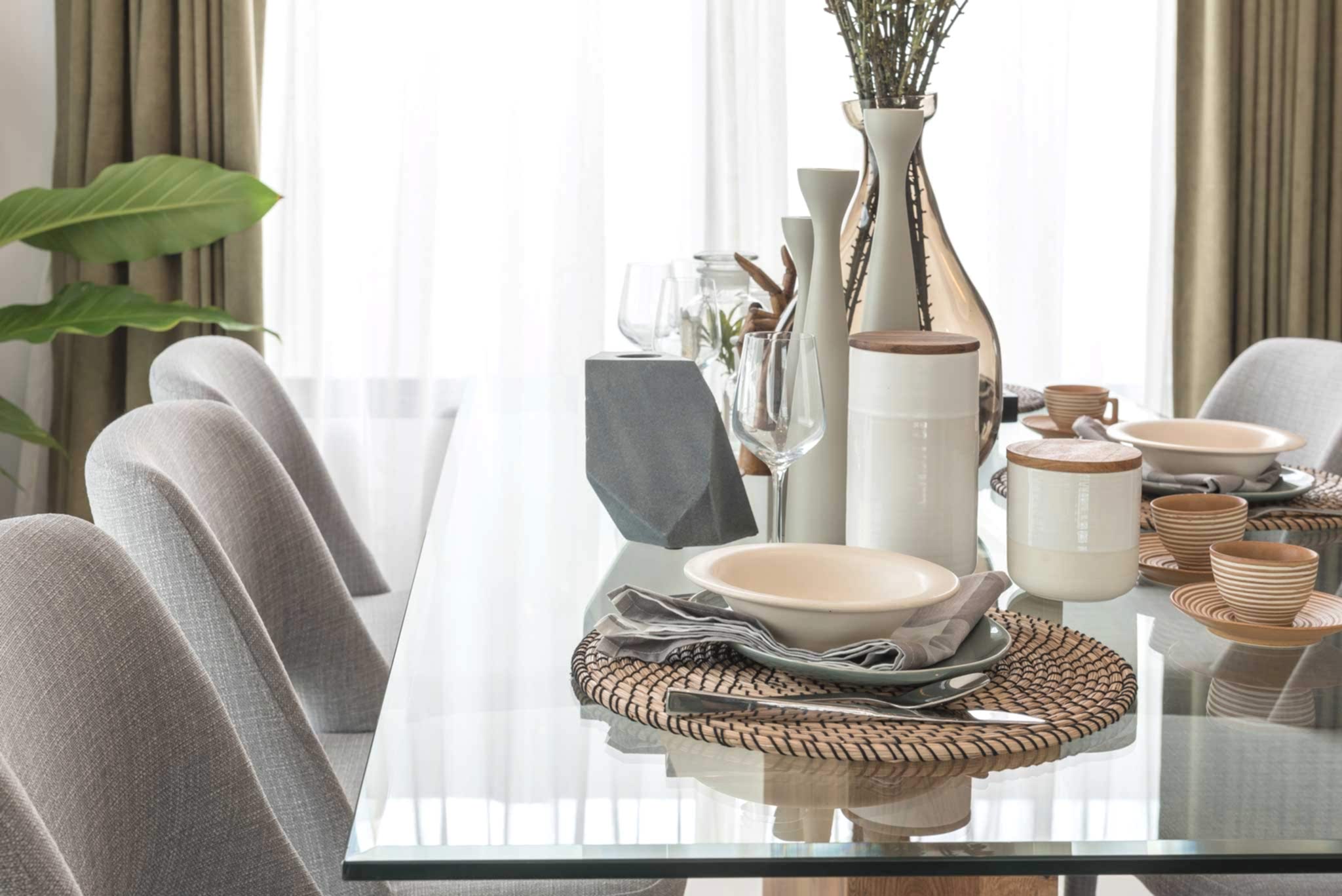 table set on glass dining table in modern dining room