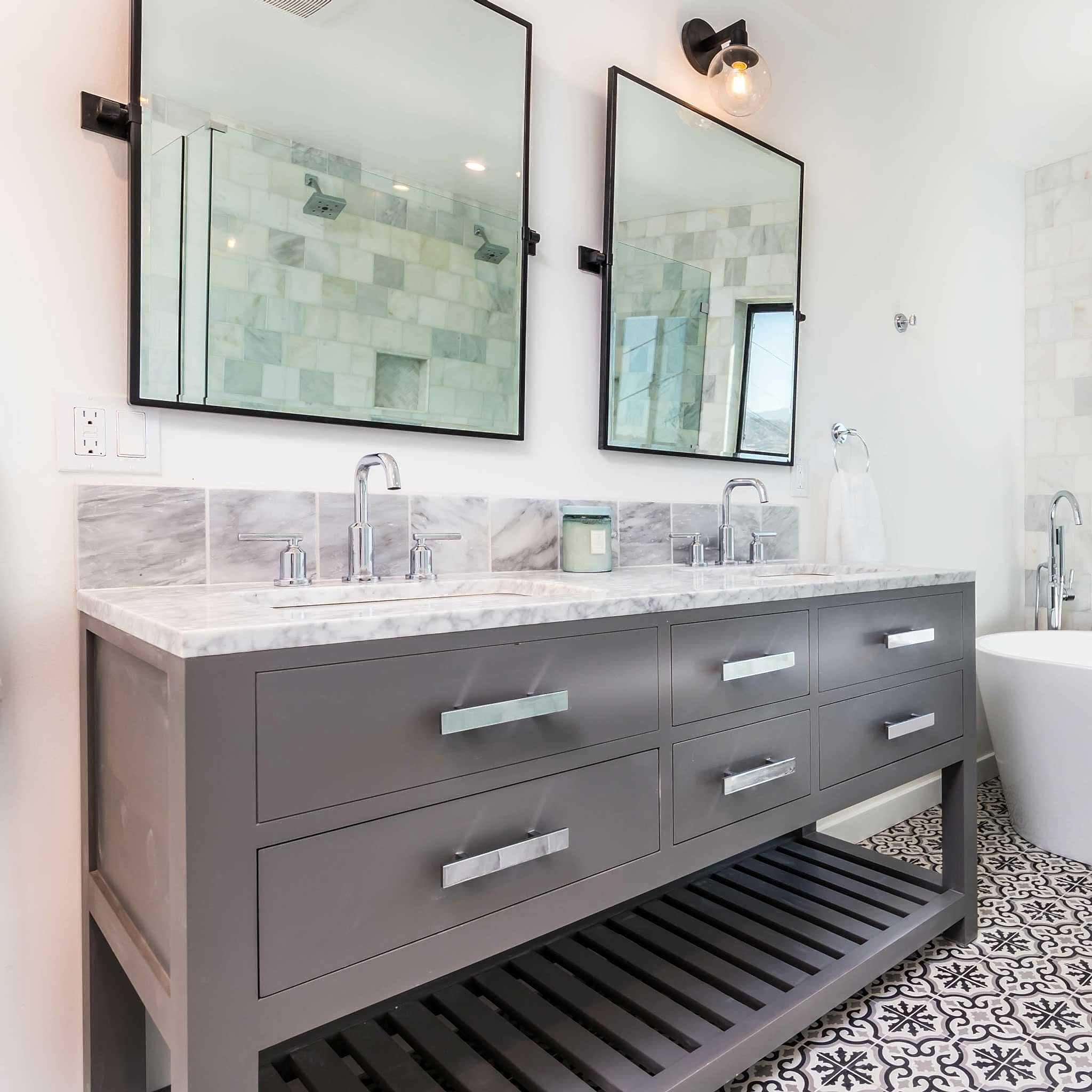 Double bathroom sink with marble countertops and custom wall mirrors installed by 5 Islands Glass & Mirror, a local glass company