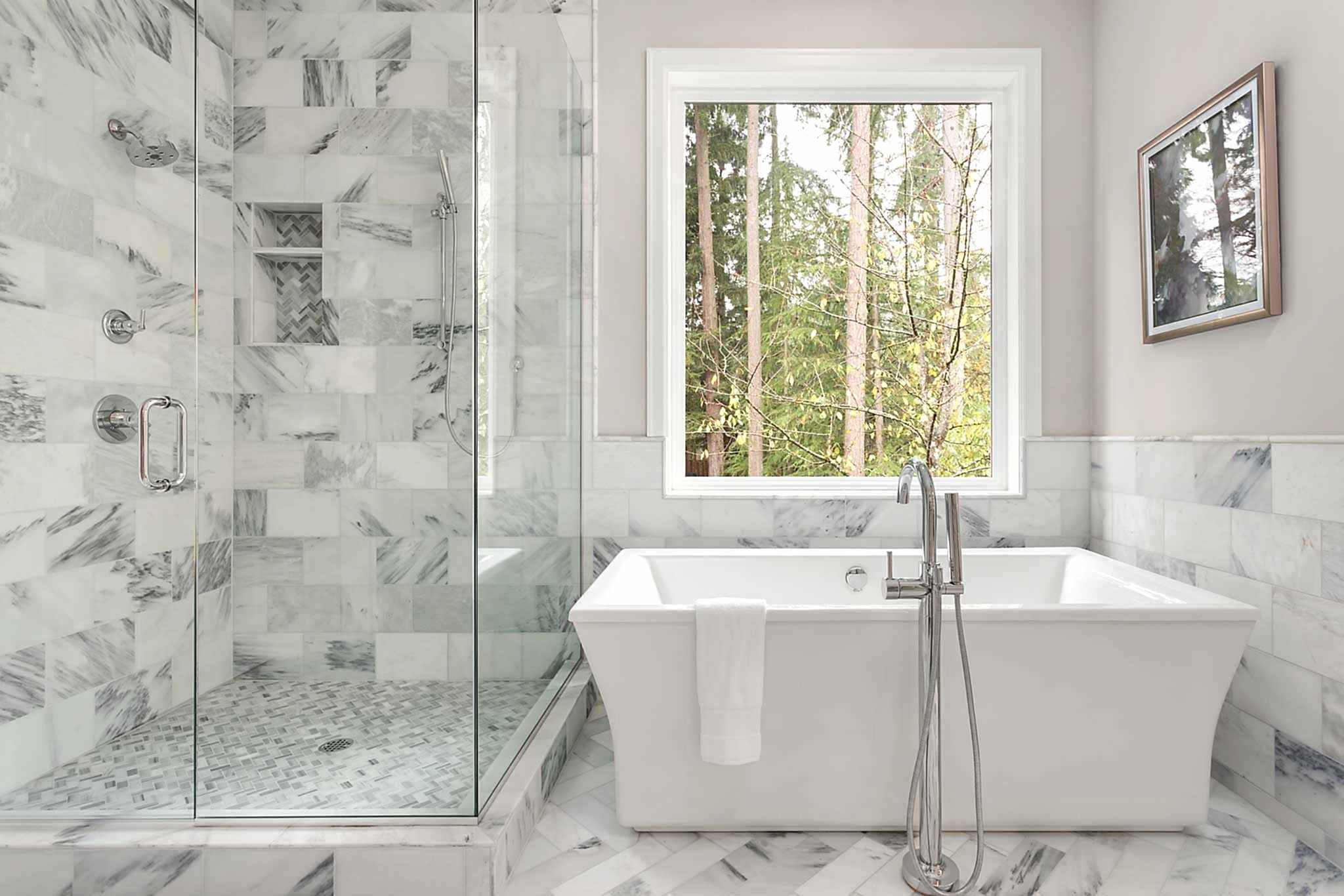 Bathroom with bathtub and shower in new luxury home with all glass shower.